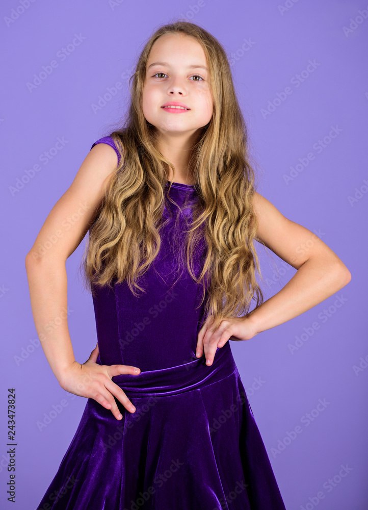 Kids fashion. Girl cute child wear velvet violet dress. Clothes for ballroom dance. Kid fashionable dress looks adorable. Ballroom dancewear fashion concept. Kid dancer satisfied with concert outfit