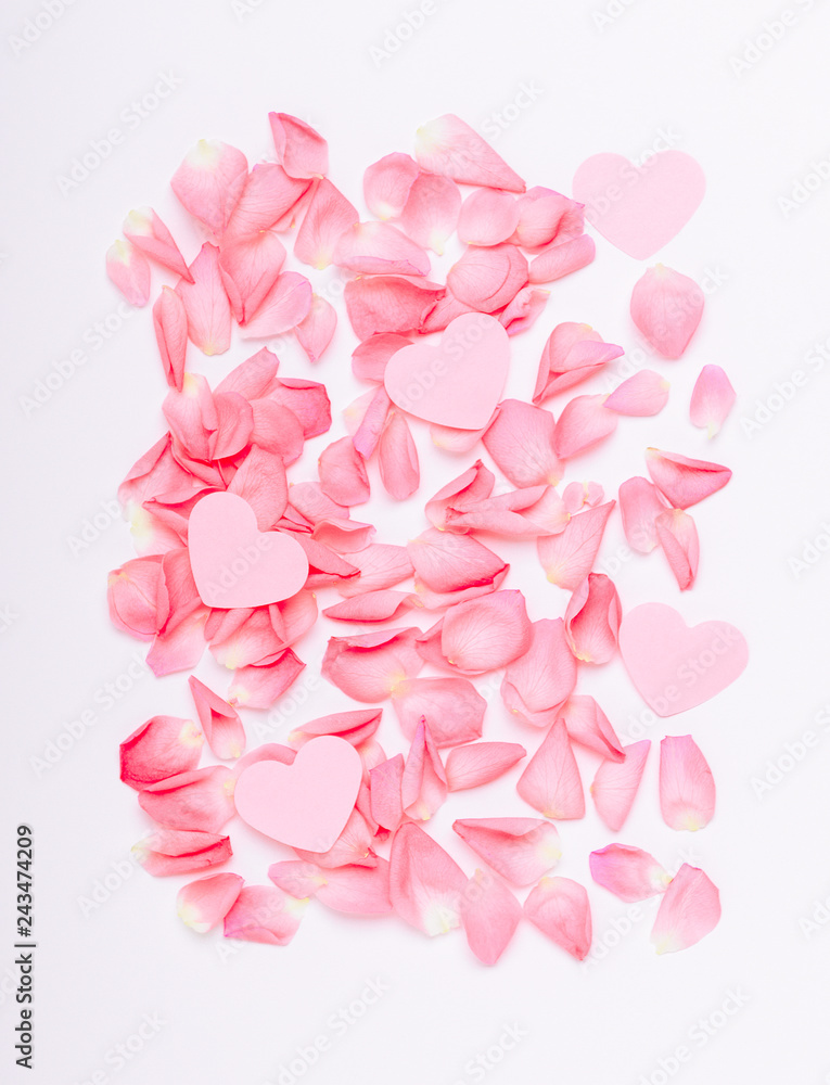 Fototapeta premium The composition of pink roses and hearts. Floral background for the holiday Women's Day, Valentine's, Mother's Day. Copy space, top view, flat lay