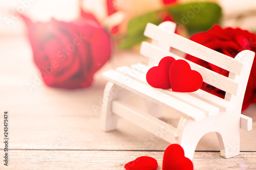 Concept of Valentine, anniversary, wedding celebration, heart shapes on a white wooden bench, bokeh background, close up