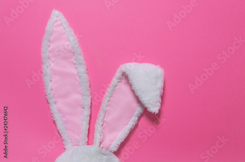 hare ears made of white fur on pink pastel background. The concept of Easter