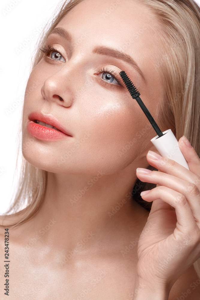 Beautiful young girl with a light natural make-up,mascara and nude manicure. Beauty face.