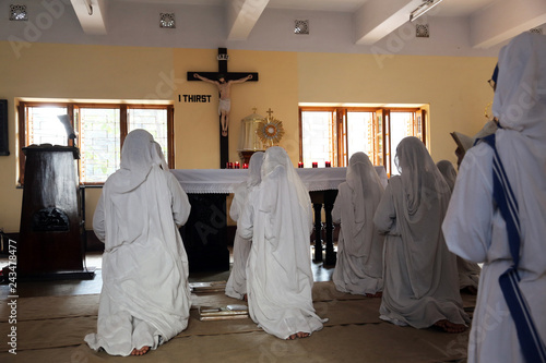 Sisters of Mother Teresa's Missionaries of Charity in prayer in the chapel of the Mother House, Kolkata, India  photo