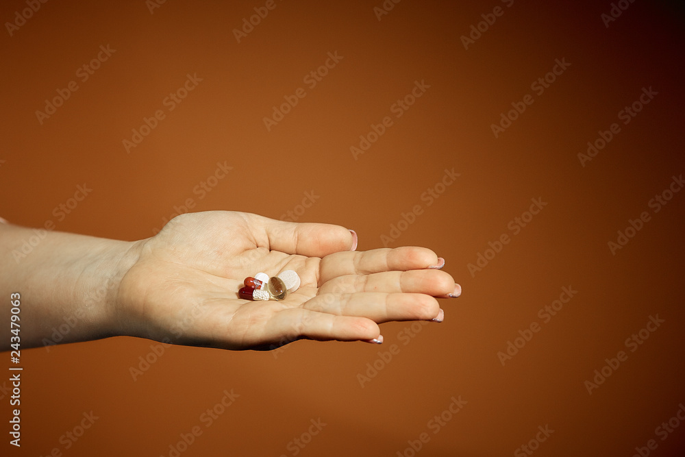 woman holding a pill in her hand, treatment of colds woman holding a pill in her hand, treatment of colds
