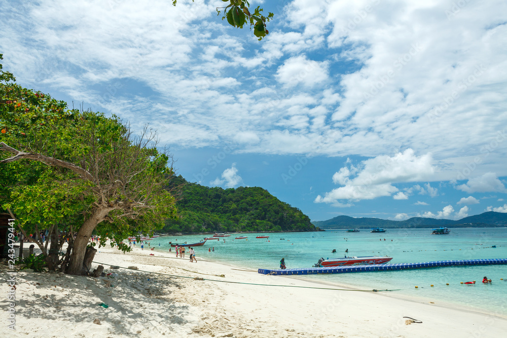 a floating pier and a motor boat on the beach of an thai island in the Andaman sea