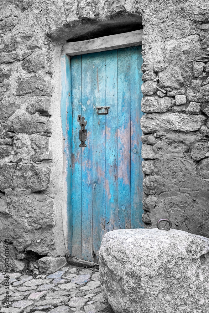 Blue door in a traditional village house of Corsica, France