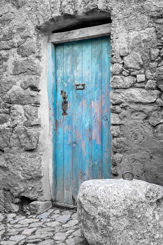 Blue door in a traditional village house of Corsica, France © ptashkan