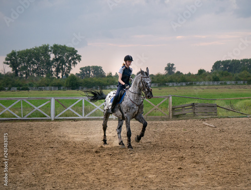 Beautiful girl jockey riding a horse