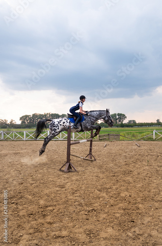 Beautiful girl jockey riding a horse