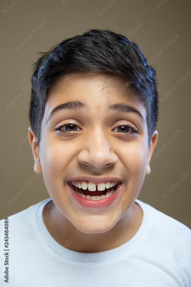 Close up portrait of cute little boy laughing against color background Close up portrait of cute little boy laughing against color background