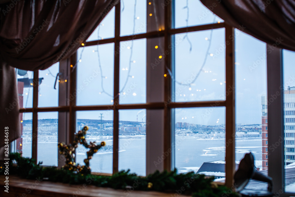 a view from a window with a decorated windowsill with Xmas star and gramophone toy a view from a window with a decorated windowsill with Xmas star and gramophone toy