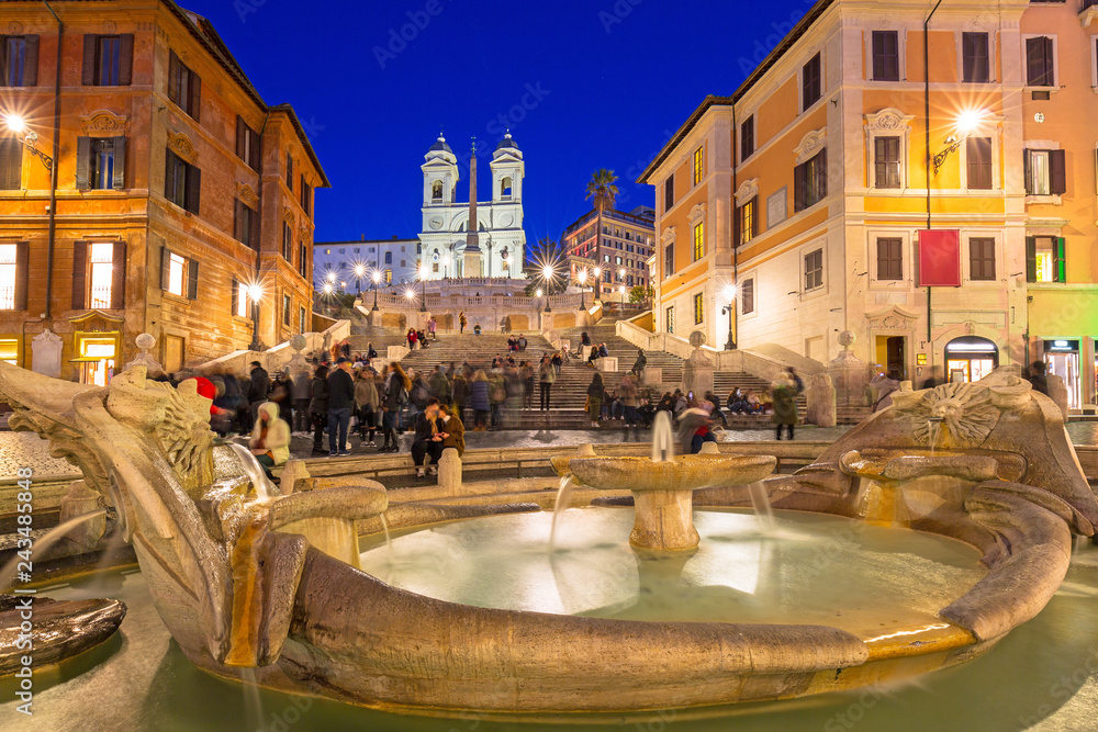 Fototapeta premium Fountain on the Piazza di Spagna square and the Spanish Steps in Rome at dusk, Italy