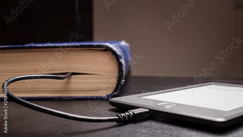 Canvas Print concept of progress and compactness, eBook connected to the old thick blue book