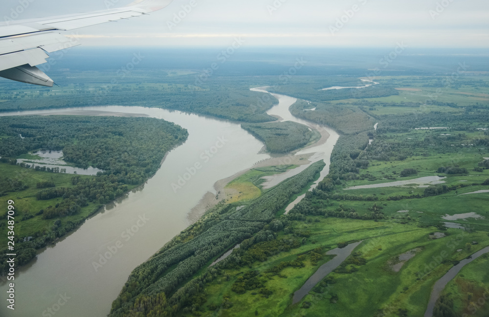Aerial view of Ob river, green meadows and forests.