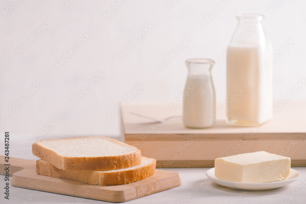 Sliced bread bake and butter on wooden cutting board. Simple breakfast Sliced bread bake and butter on wooden cutting board. Simple breakfast