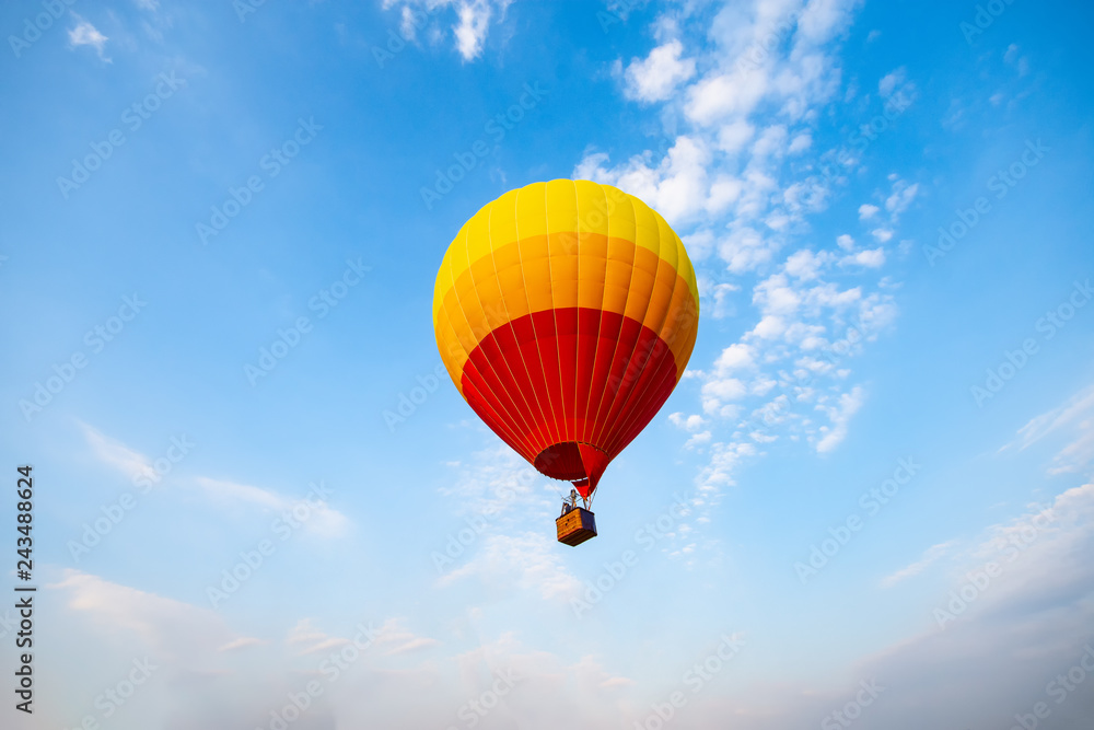 Fototapeta premium hot air balloon is flying at morning sunrise