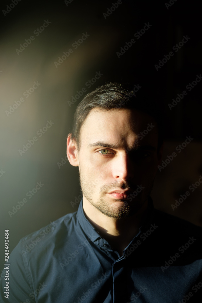 Business portrait of a handsome young man in a dark blue shirt. Business portrait of a handsome young man in a dark blue shirt.