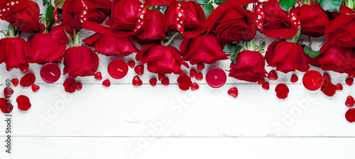 Red rose on white wooden table