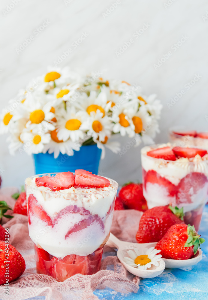 Strawberries with cream or tiramisu in small glasses 