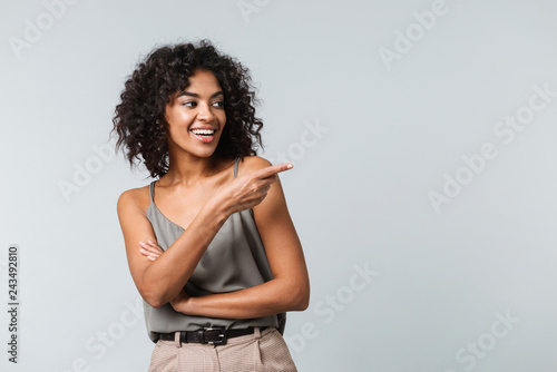 Happy young african woman casualy dressed standing photo