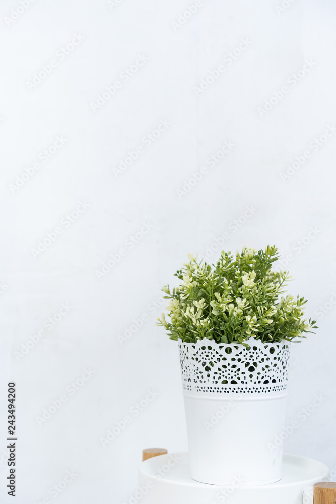 White flower pot with bright green fake trees White flower pot with bright green fake trees