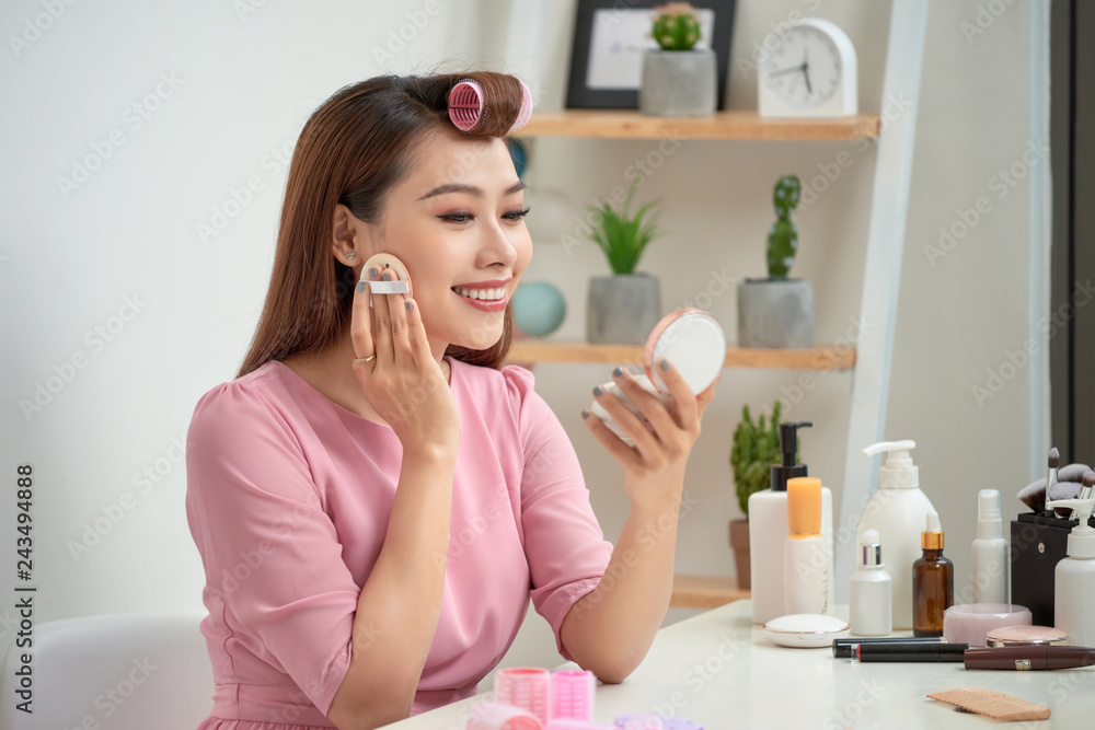 Close up portrait of charming pretty cute good-looking stylish trendy fashionable sexy applying powder with sponge on cheeks looking in mirror in morning Close up portrait of charming pretty cute good-looking stylish trendy fashionable sexy applying powder with sponge on cheeks looking in mirror in morning