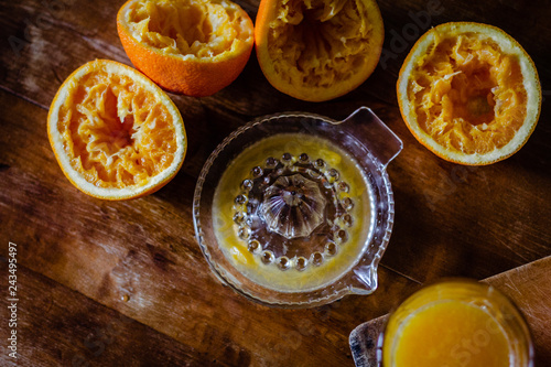 Oranges and squeezer on wooden table