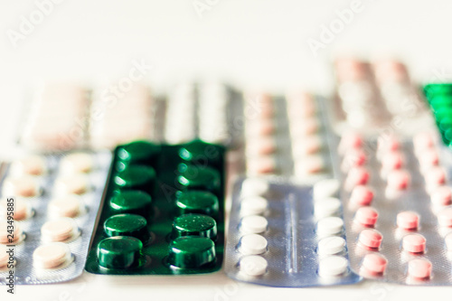 Medicine pills or capsules blister pack on white background with copy space. Drug prescription for treatment medication.