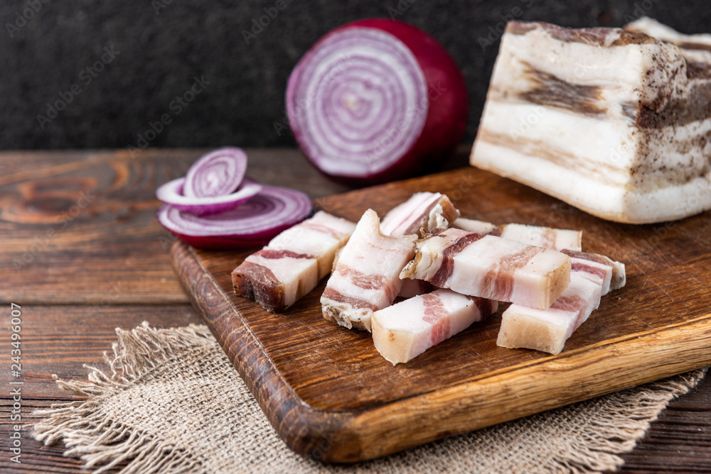 Salt pork fat with onion on wooden background. Salt pork fat with onion on wooden background.