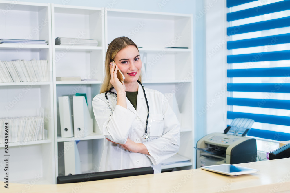 young beautiful woman doctor talking on phone in office young beautiful woman doctor talking on phone in office