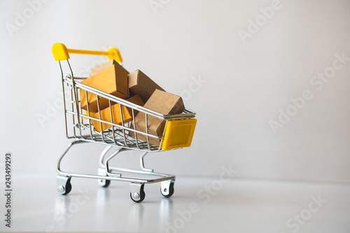 Mini shopping cart contain paper box using as e-commerce, online shopping and business marketing concept