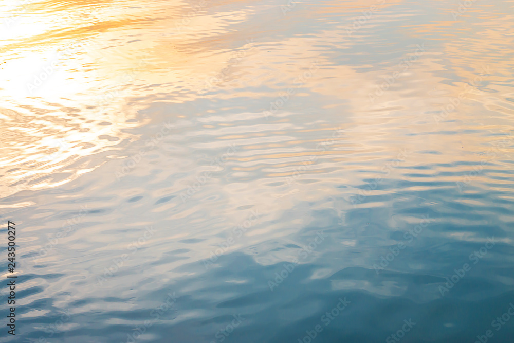 Golden light reflected on the surface of the evening water. Golden light reflected on the surface of the evening water.