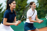Fit happy poeple playing tennis together. Sport concept