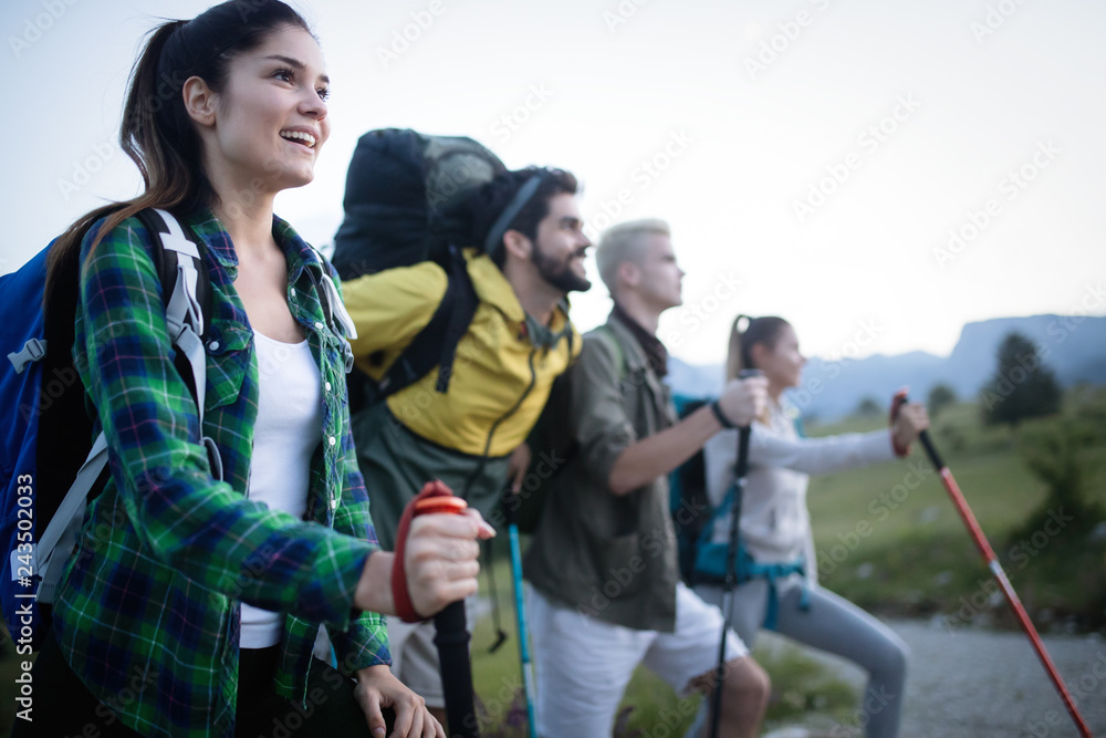 Young friends on a country walk. Group of people hiking through countryside Young friends on a country walk. Group of people hiking through countryside