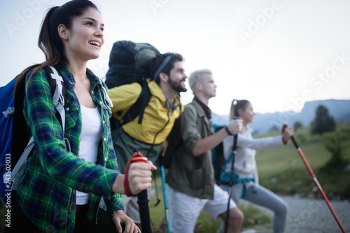 Young friends on a country walk. Group of people hiking through countryside