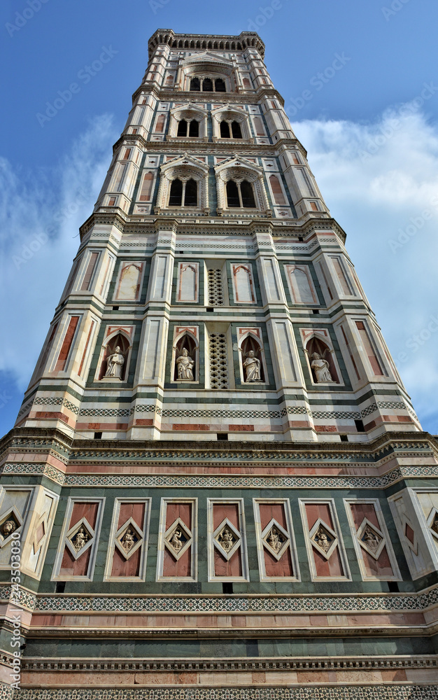 Giotto's Campanile stands adjacent to the Florence Cathedral. It is 84.7 meters tall. The tower has rich sculptural decorations & polychrome marble encrustations. Gothic architecture. Italy, Florence. Giotto's Campanile stands adjacent to the Florence Cathedral. It is 84.7 meters tall. The tower has rich sculptural decorations & polychrome marble encrustations. Gothic architecture. Italy, Florence.