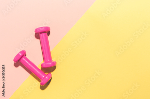 Dumbbells flat lay on pink and yellow © nerudol