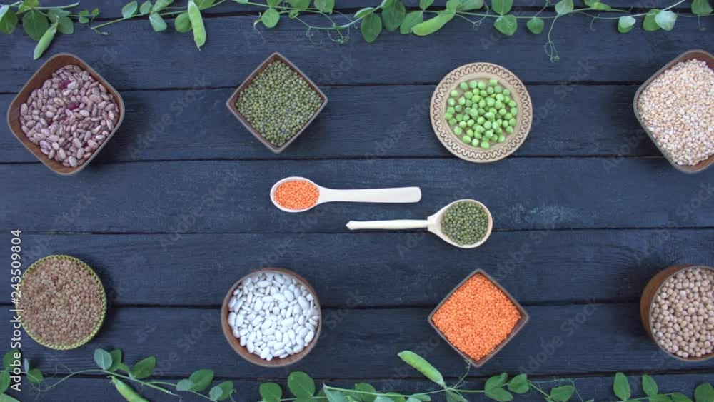 Legumes on dark wooden ecological background. Beans are located in