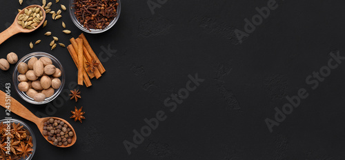 Aroma spices for christmas pastry on black background © Prostock-studio