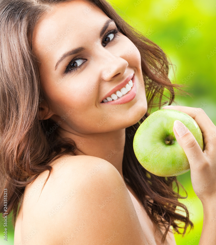 Young happy smiling woman with apple, outdoors Young happy smiling woman with apple, outdoors