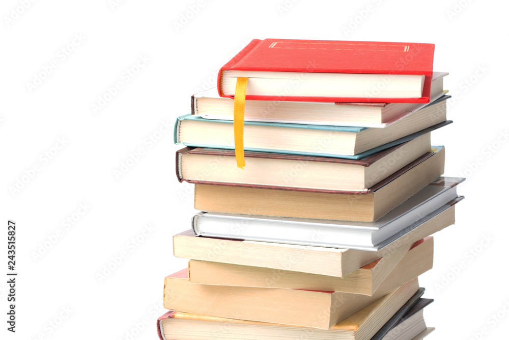 Stack of different books with book with yellow bookmark on its top isolated on a white background Stack of different books with book with yellow bookmark on its top isolated on a white background