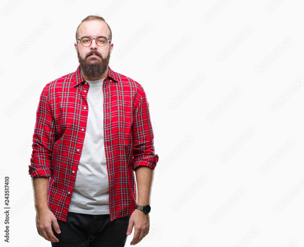 Young caucasian hipster man wearing glasses over isolated background with serious expression on face. Simple and natural looking at the camera. Young caucasian hipster man wearing glasses over isolated background with serious expression on face. Simple and natural looking at the camera.