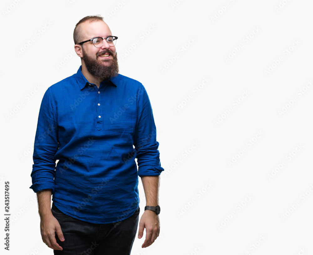 Fototapeta premium Young caucasian hipster man wearing glasses over isolated background looking away to side with smile on face, natural expression. Laughing confident.