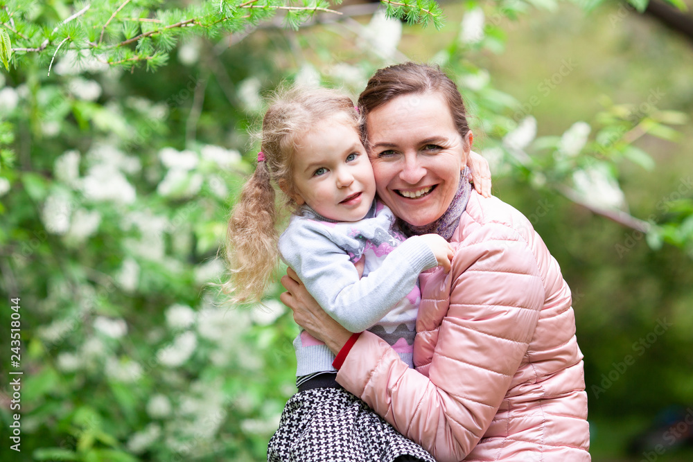 Portrait of mother with daughter in summer park. Portrait of mother with daughter in summer park.