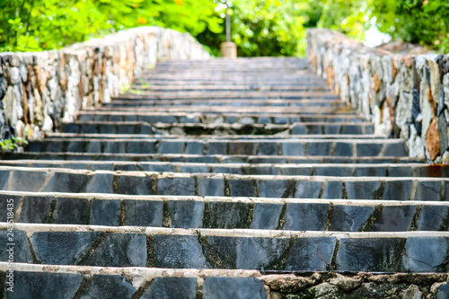 Granite stairs and stone walls in the garden and green plant