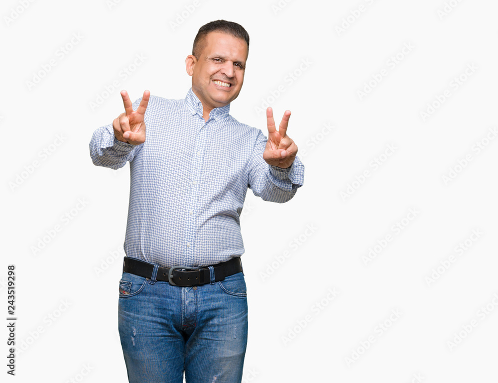 Middle age arab business man over isolated background smiling looking to the camera showing fingers doing victory sign. Number two. Middle age arab business man over isolated background smiling looking to the camera showing fingers doing victory sign. Number two.