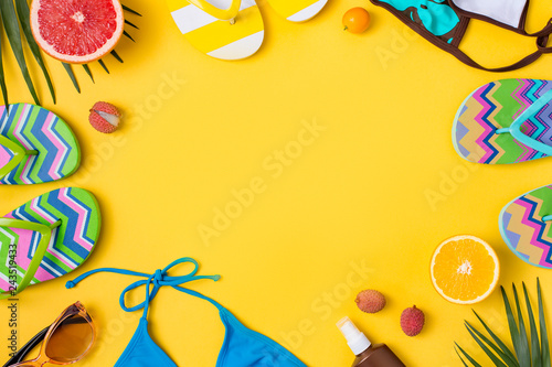 Beach accessories on yellow background