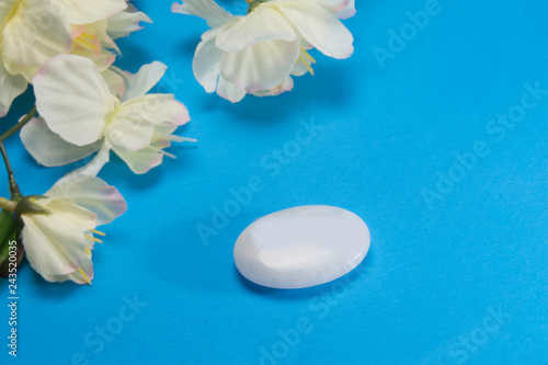 White flowers with a stone that depicts peace