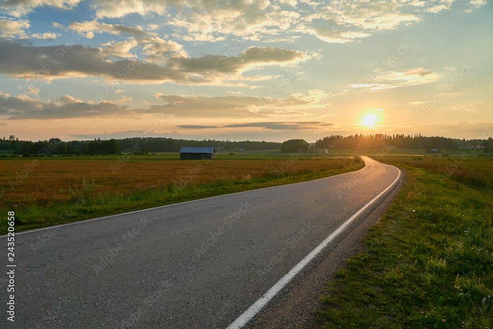 Empty countryside road between fields