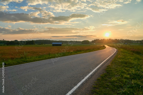 Empty countryside road between fields © PekkaLinna