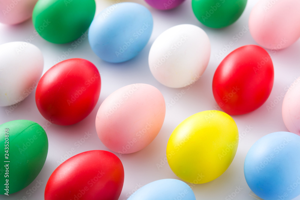 Easter holidays concept with colorful easter eggs pattern on white background. Close up Easter holidays concept with colorful easter eggs pattern on white background. Close up